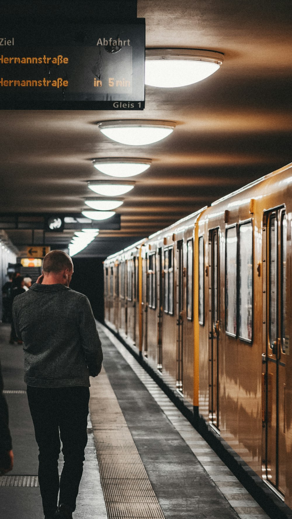 man walking near subway train