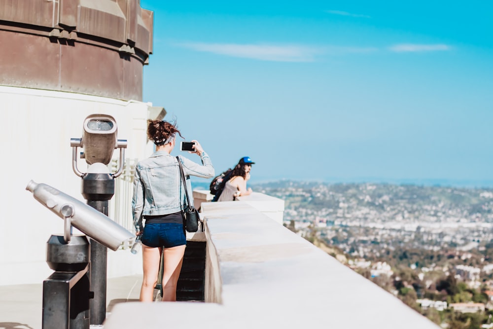 woman standing on terrace facing city