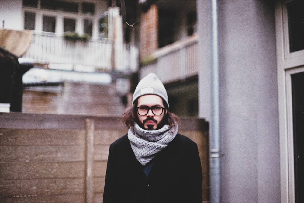 man wearing scarf near building