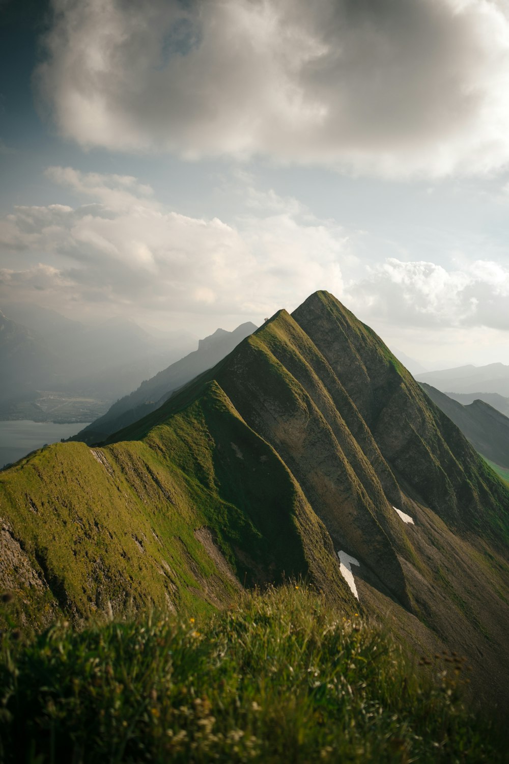 mountain view near body of water under cloudy sky