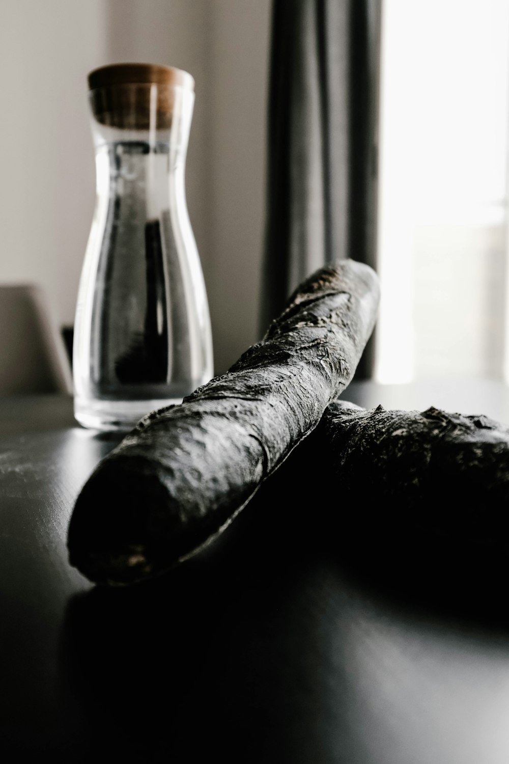 two black cigars near bottle