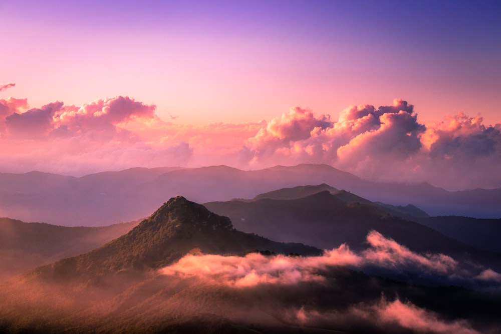 green mountain surrounded by clouds