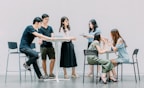 two men and four women meeting in office