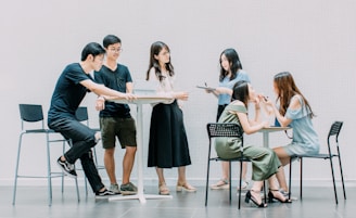 two men and four women meeting in office