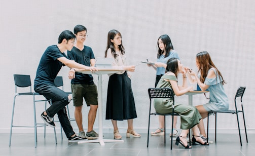 two men and four women meeting in office