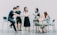 two men and four women meeting in office