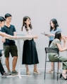 two men and four women meeting in office