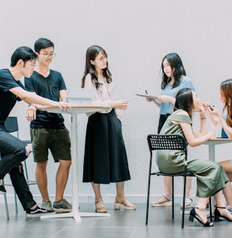 two men and four women meeting in office