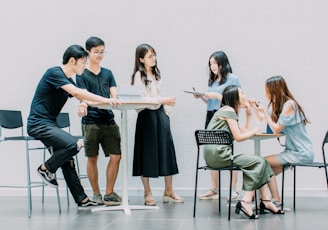 two men and four women meeting in office