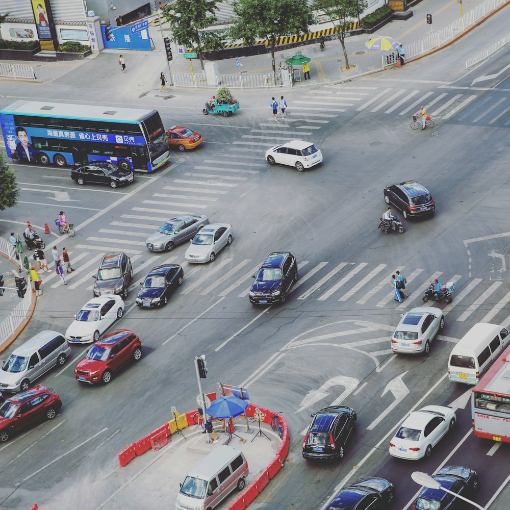 intersection road with vehicle traveling and people crossing on pedestrian lane