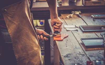 person holding black and silver hand tool