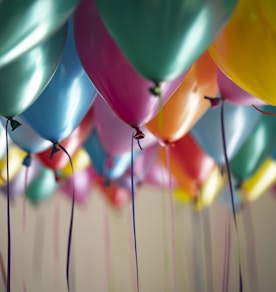 selective focus photography of assorted-color balloons