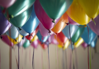 selective focus photography of assorted-color balloons