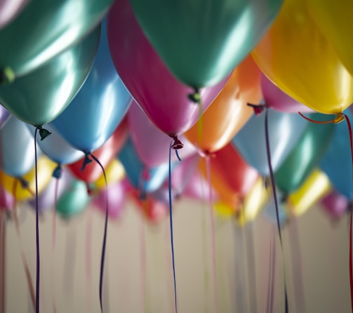 selective focus photography of assorted-color balloons