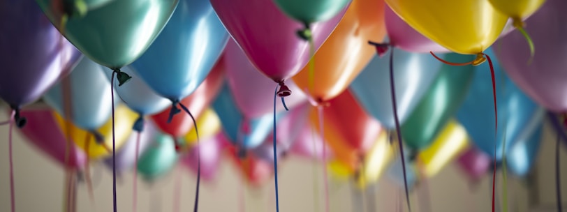 selective focus photography of assorted-color balloons