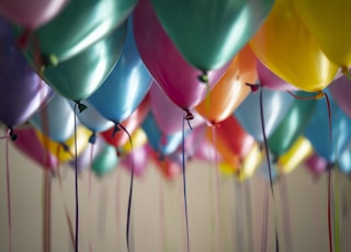 selective focus photography of assorted-color balloons