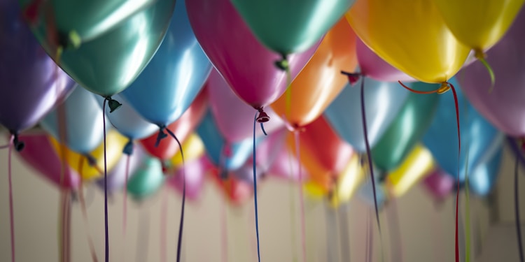 selective focus photography of assorted-color balloons