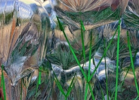 Reflective foil-like materials wrapping around and creating uneven surfaces with green stick-like elements protruding throughout.