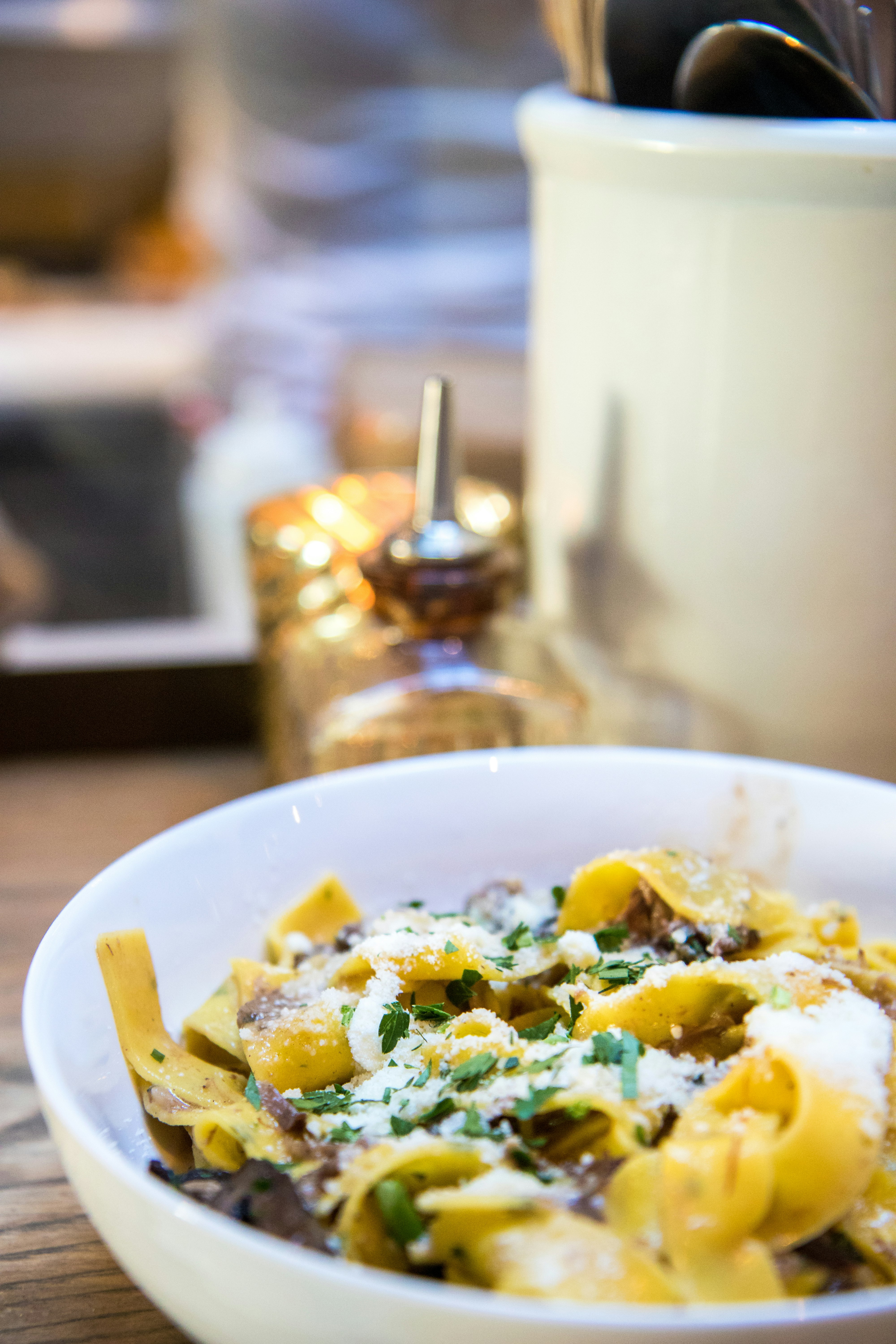 pasta with sauce on plate near bottle