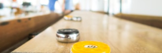 two black and yellow trinkets on table