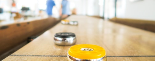 two black and yellow trinkets on table