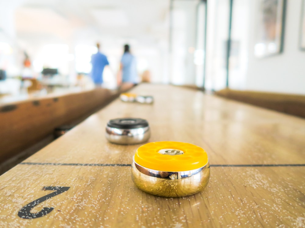 two black and yellow trinkets on table