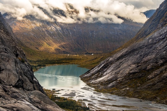 landscape photography of body of water between mountain in Nigardsbreen Norway