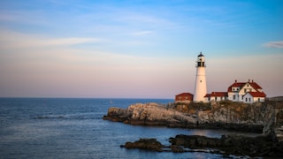 white lighthouse near body of water