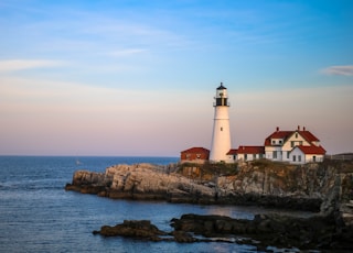 white lighthouse near body of water