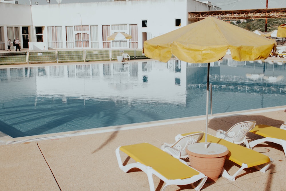 lounger and patio umbrella near pool