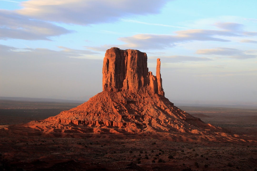 landscape photo of monolith, This shot is taken at sunset from a balcony of a room in The View Hotel in Monument Valley