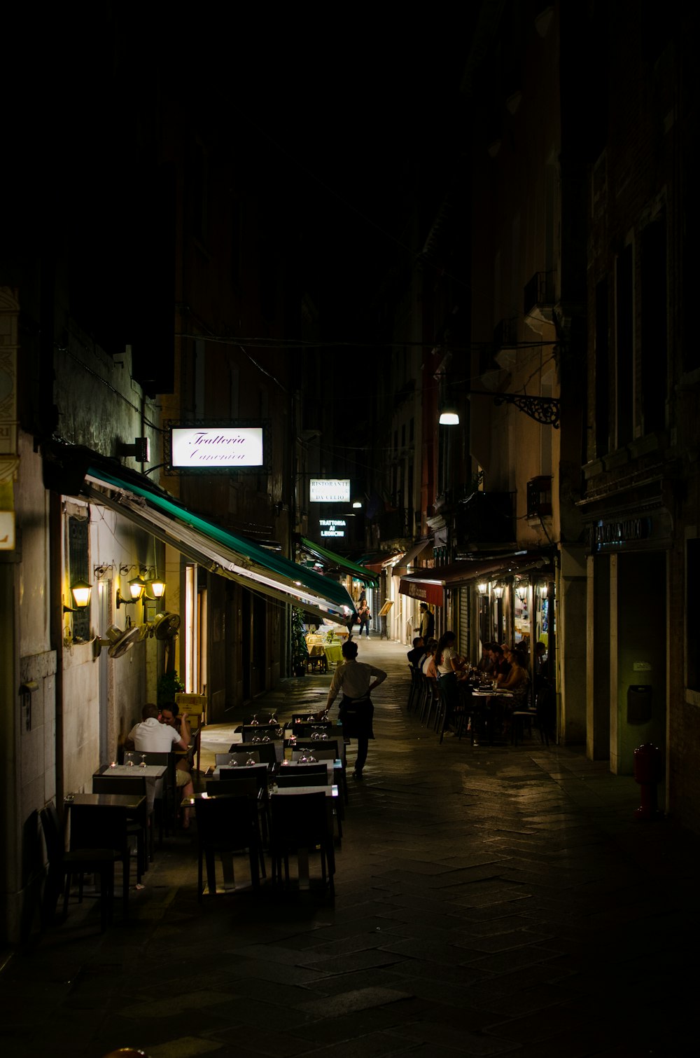 person standing beside table between building