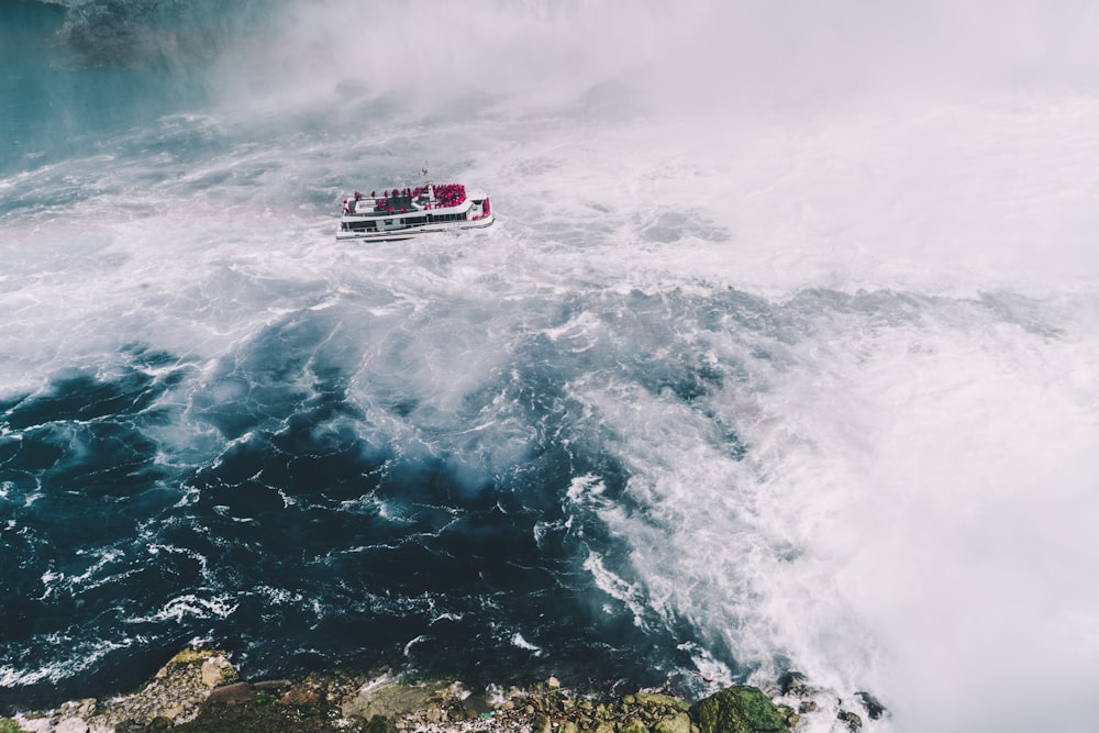 ship on body of water near waterfalls