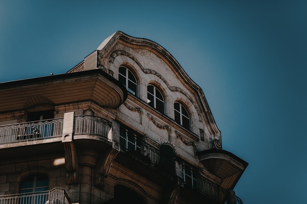 low angle photography of brown and white high-rise building