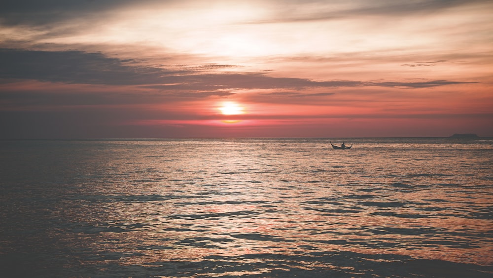 boat on sea during golden hour