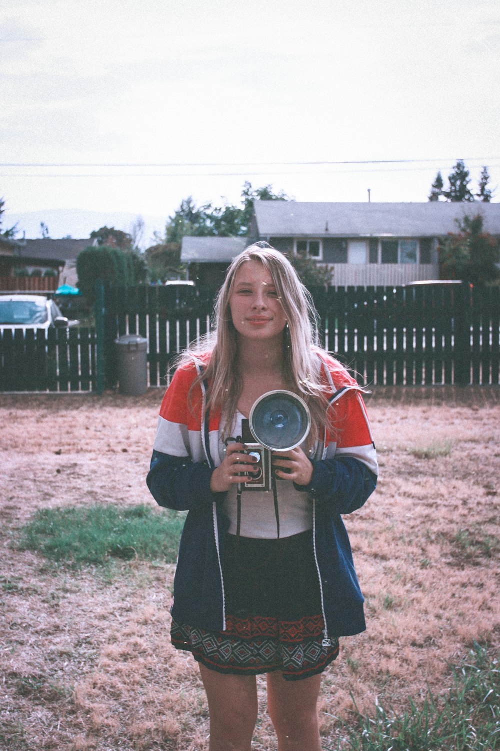 woman holding vintage camera