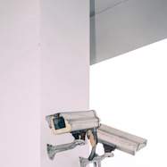 two bullet security camera attached on wall