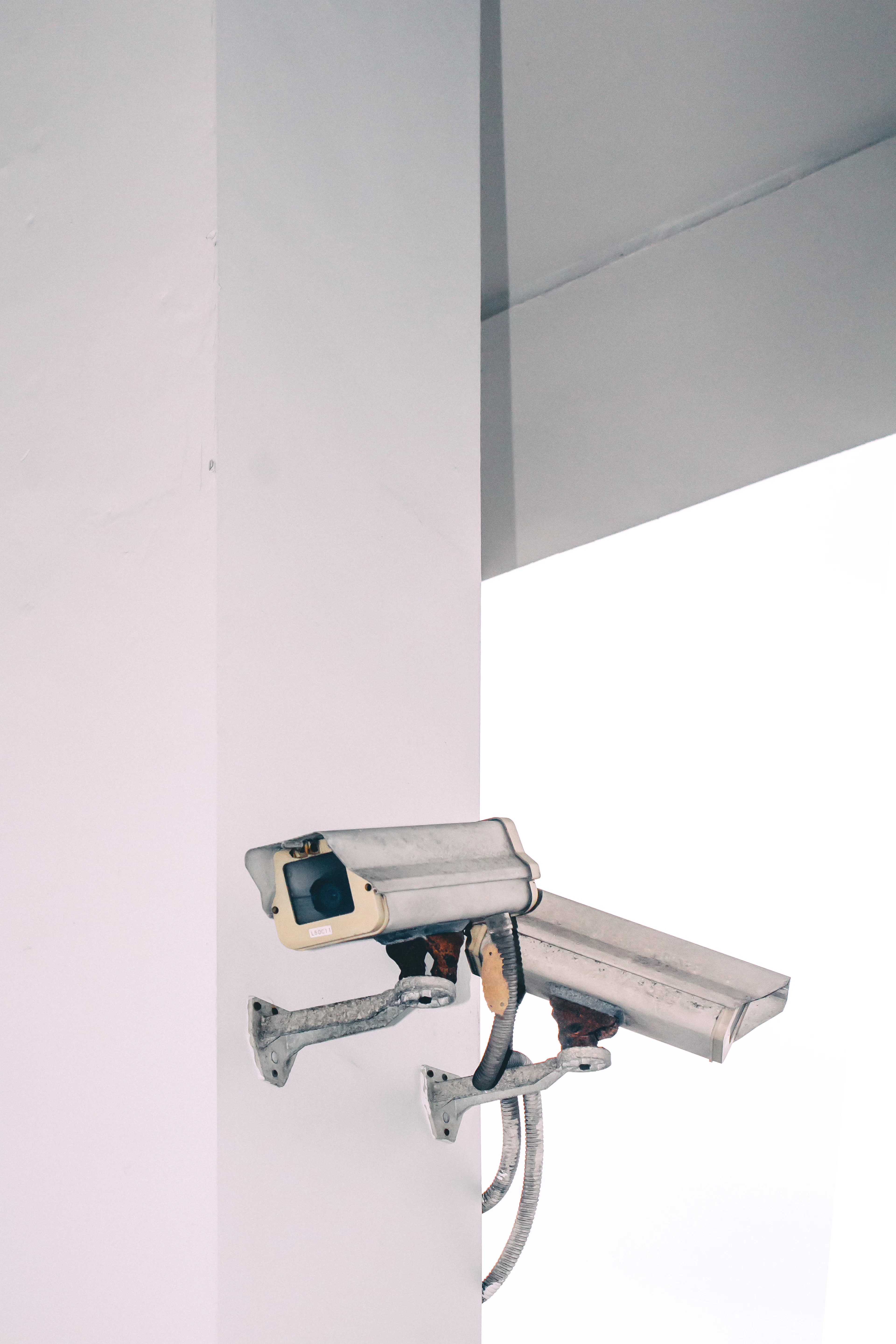 Two bullet security cameras mounted on an exterior wall