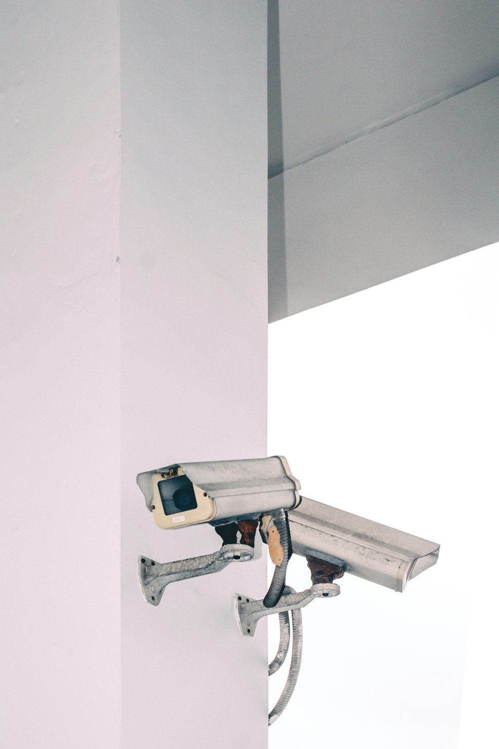 two bullet security camera attached on wall
