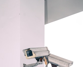 two bullet security camera attached on wall