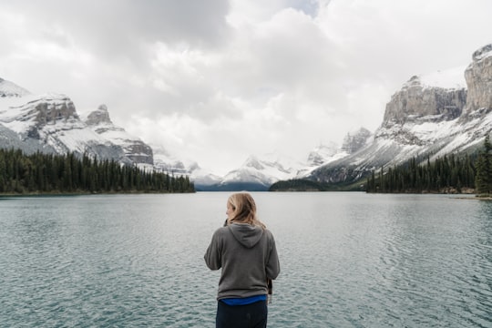 woman standing in front of lake and mountains in Jasper National Park Of Canada Canada
