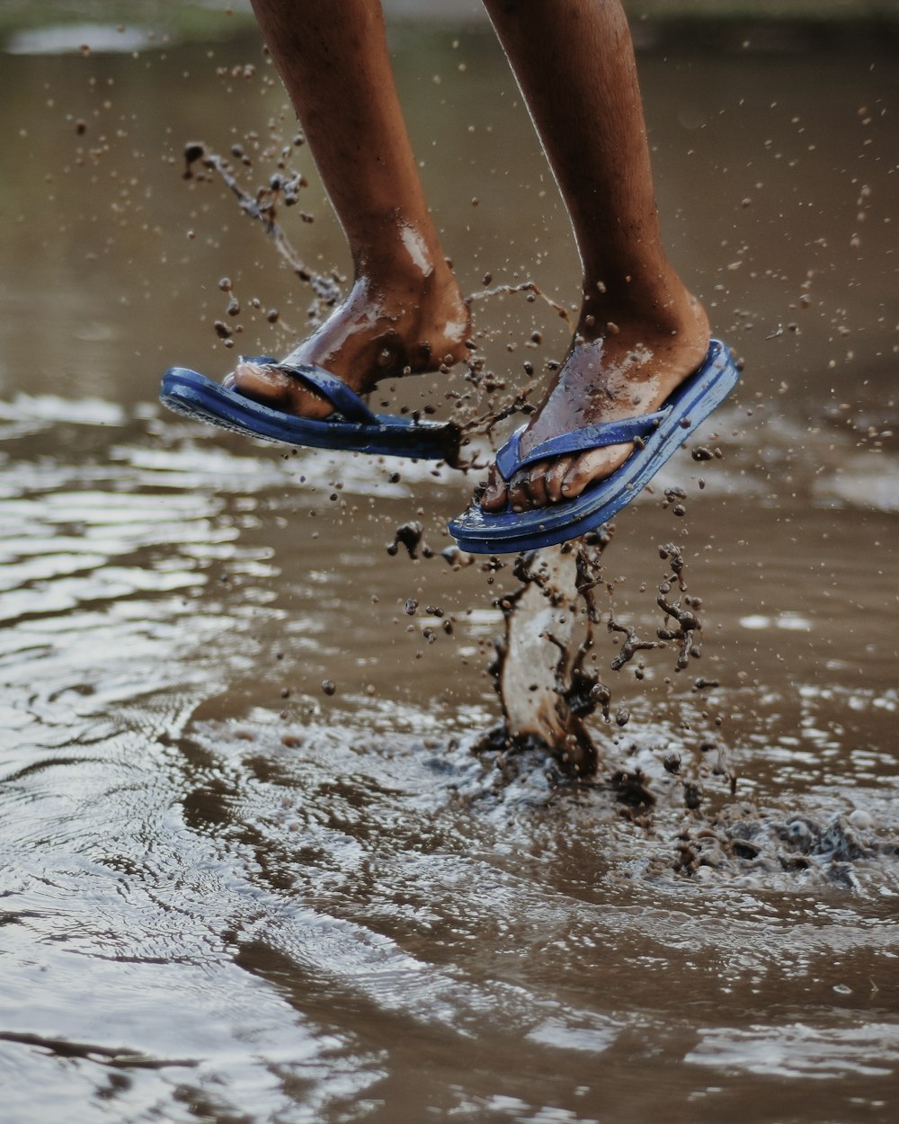 person wearing blue flip-flops