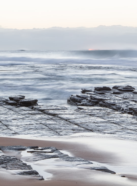 ocean waves hitting the rocky coastline in Turimetta Beach Australia