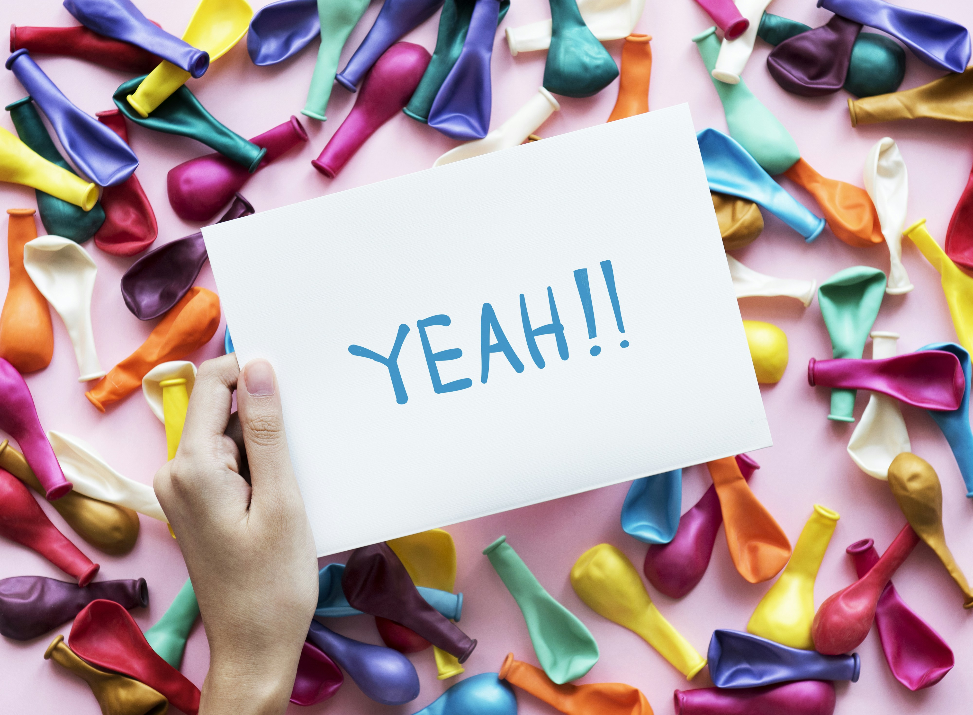 person holding Yeah!! printer paper