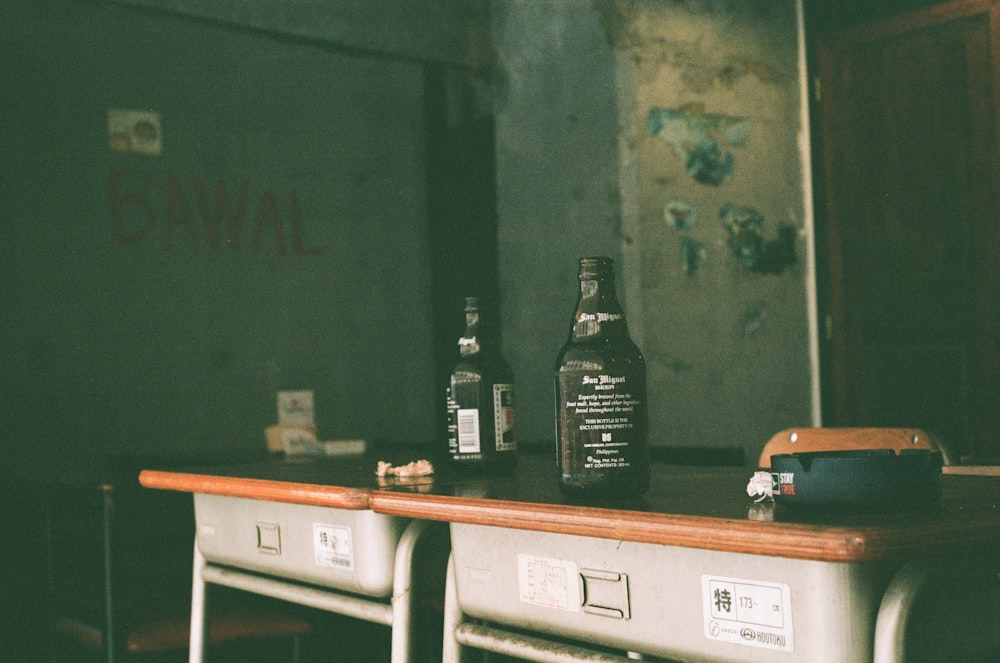 two beer bottles place on table