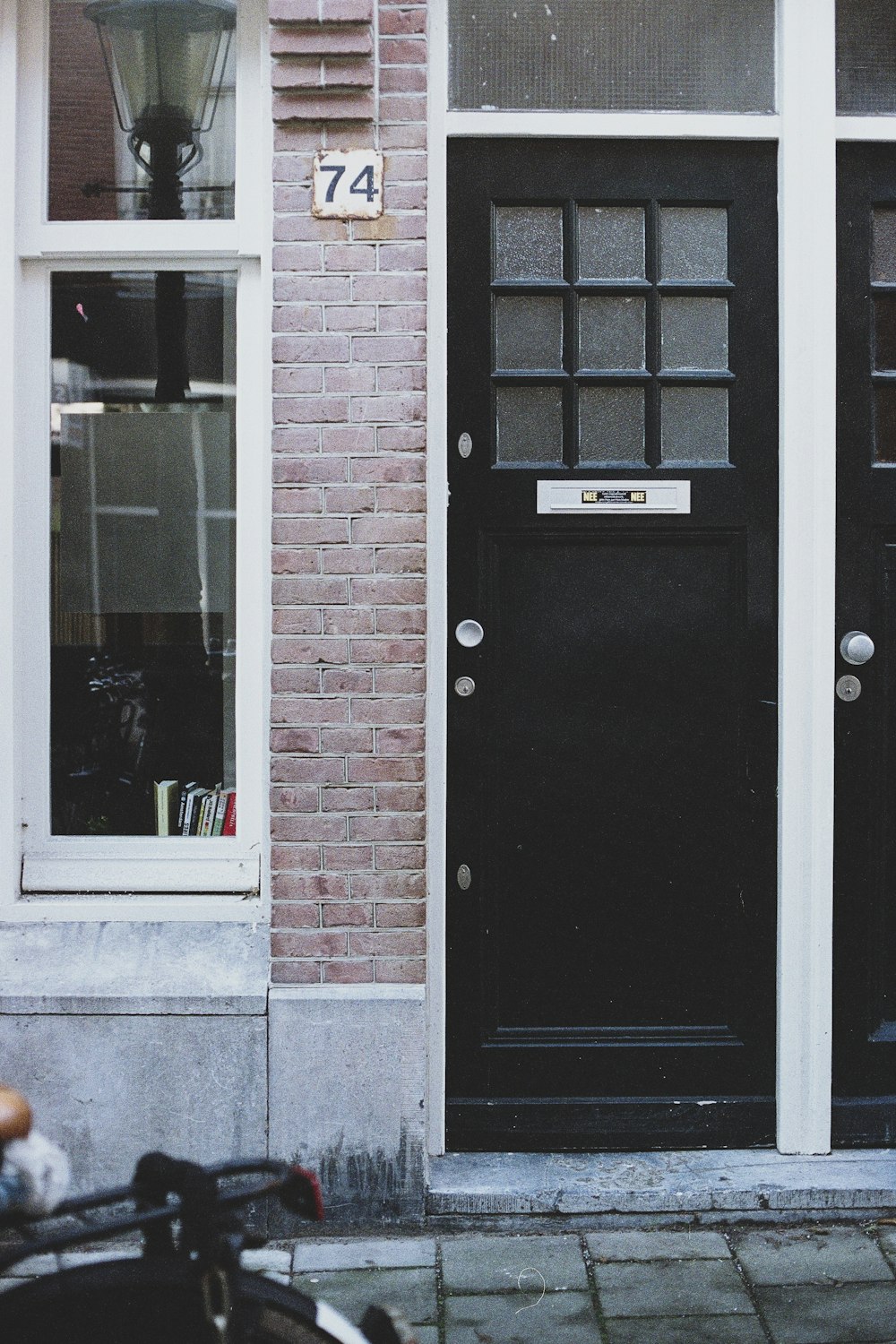 black door beside brown wall