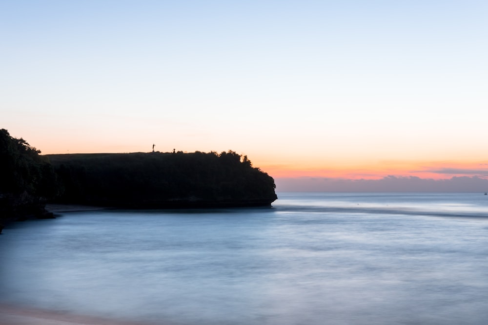 landscape photography of cliff near body of water