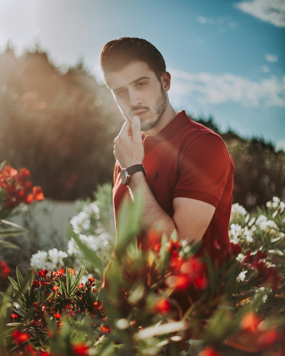 man posing for photo wearing red polo shirt