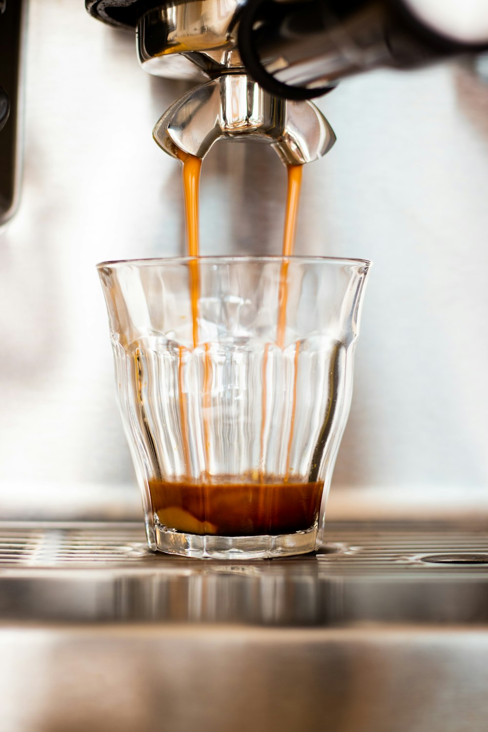 clear drinking glass with brown liquid