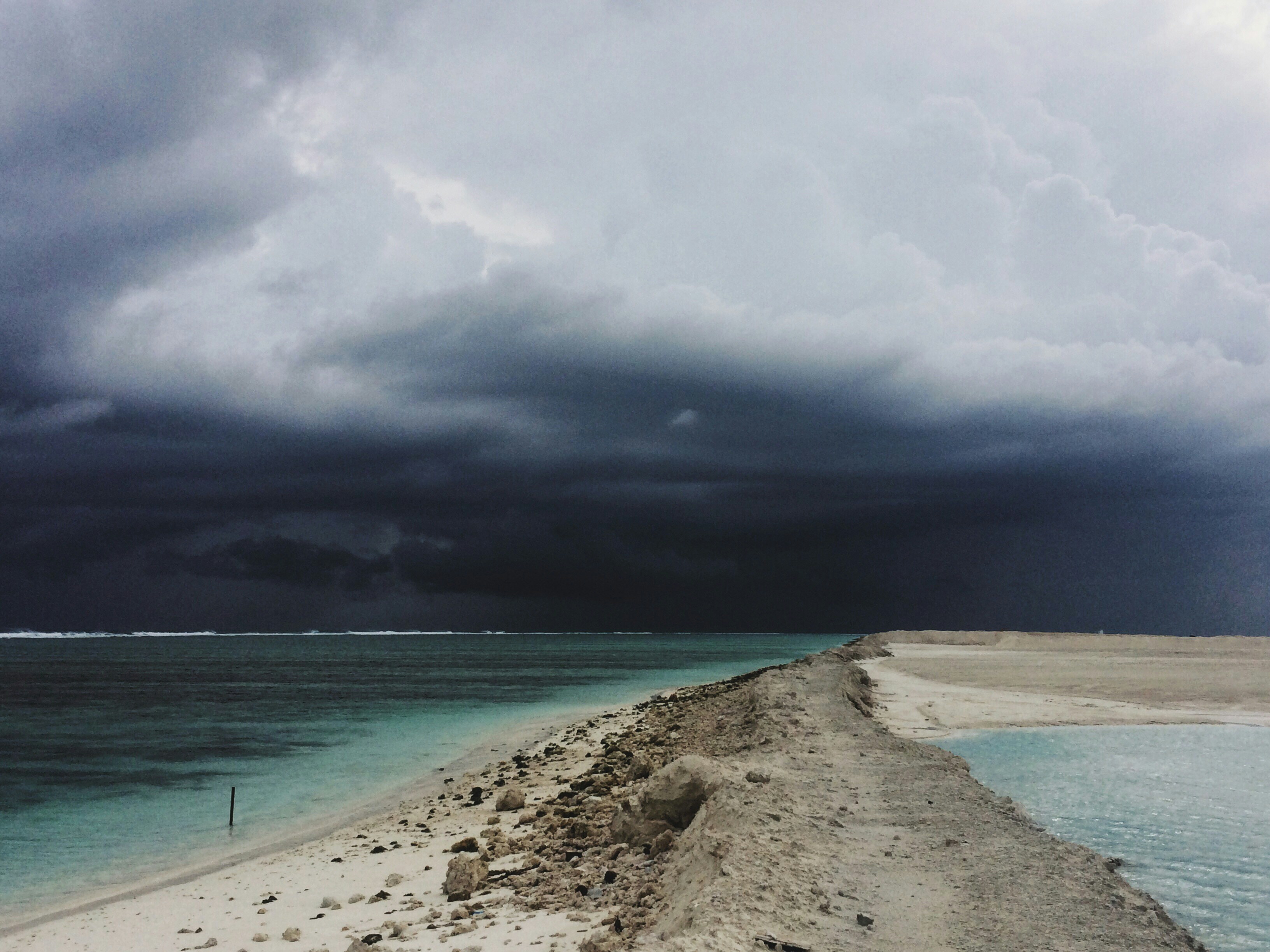 beach sand between of body of water, Tropical Storm 2